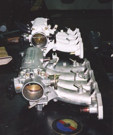 End on view of the finished intake manifold next to original intake manifold